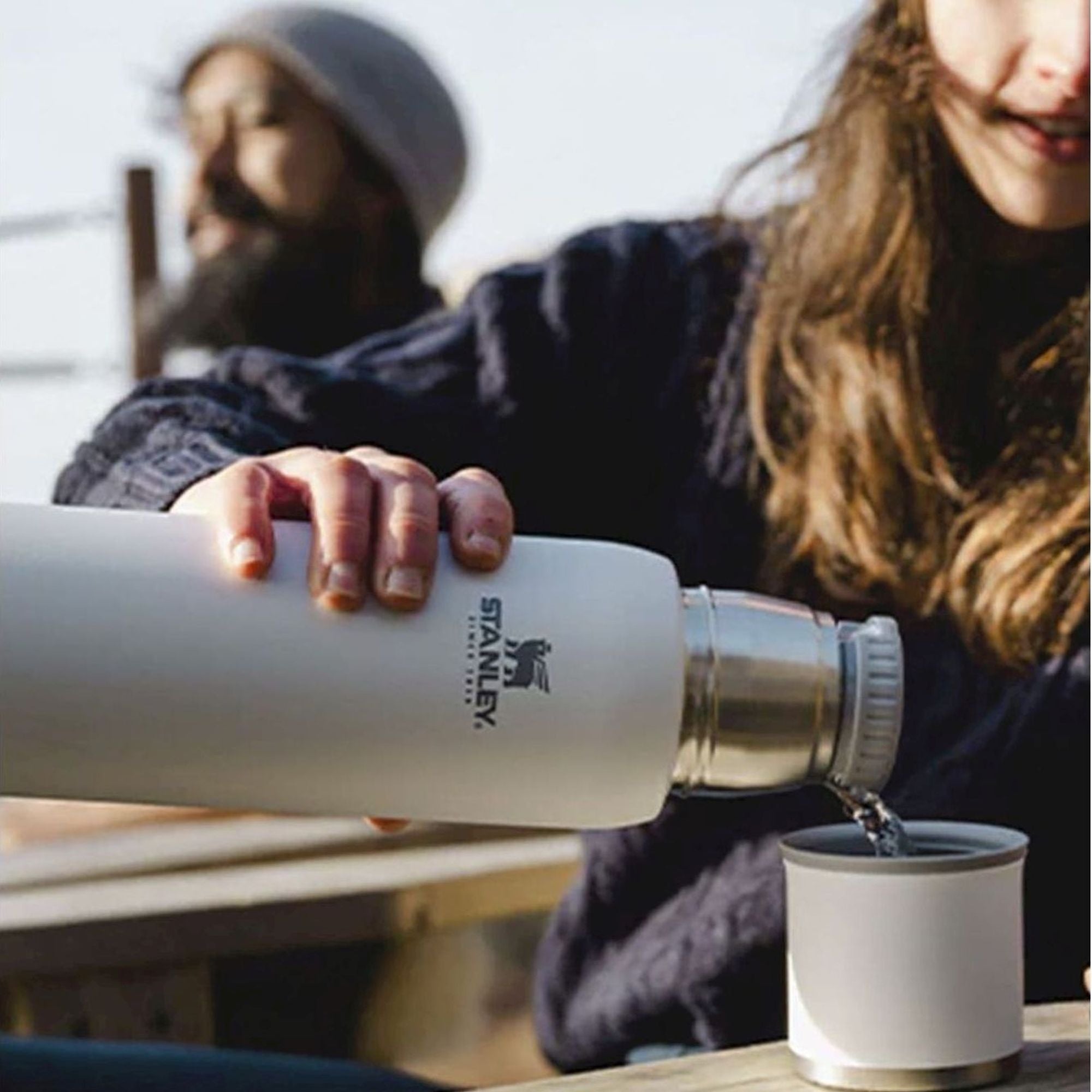 Stanley Adventure To Go 0.75L water bottle in stainless steel with a black lid and handle for outdoor hydration.