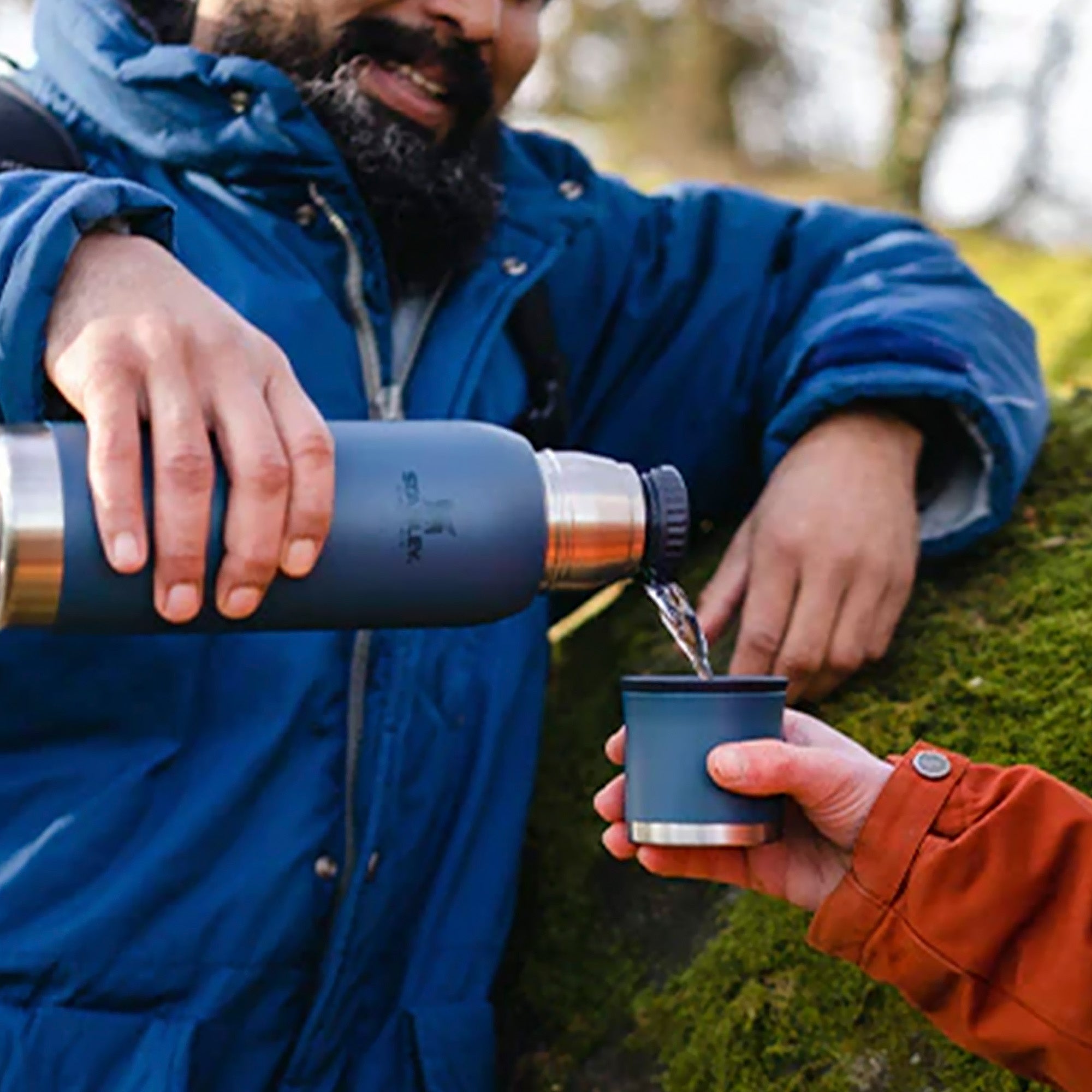 Stanley Adventure To Go 0.75L water bottle in stainless steel with a black lid, displayed on a white background.