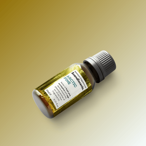 Scandiscents Arctic Pine fragrance oil bottle with pine cone and evergreen branches, natural scent display.
