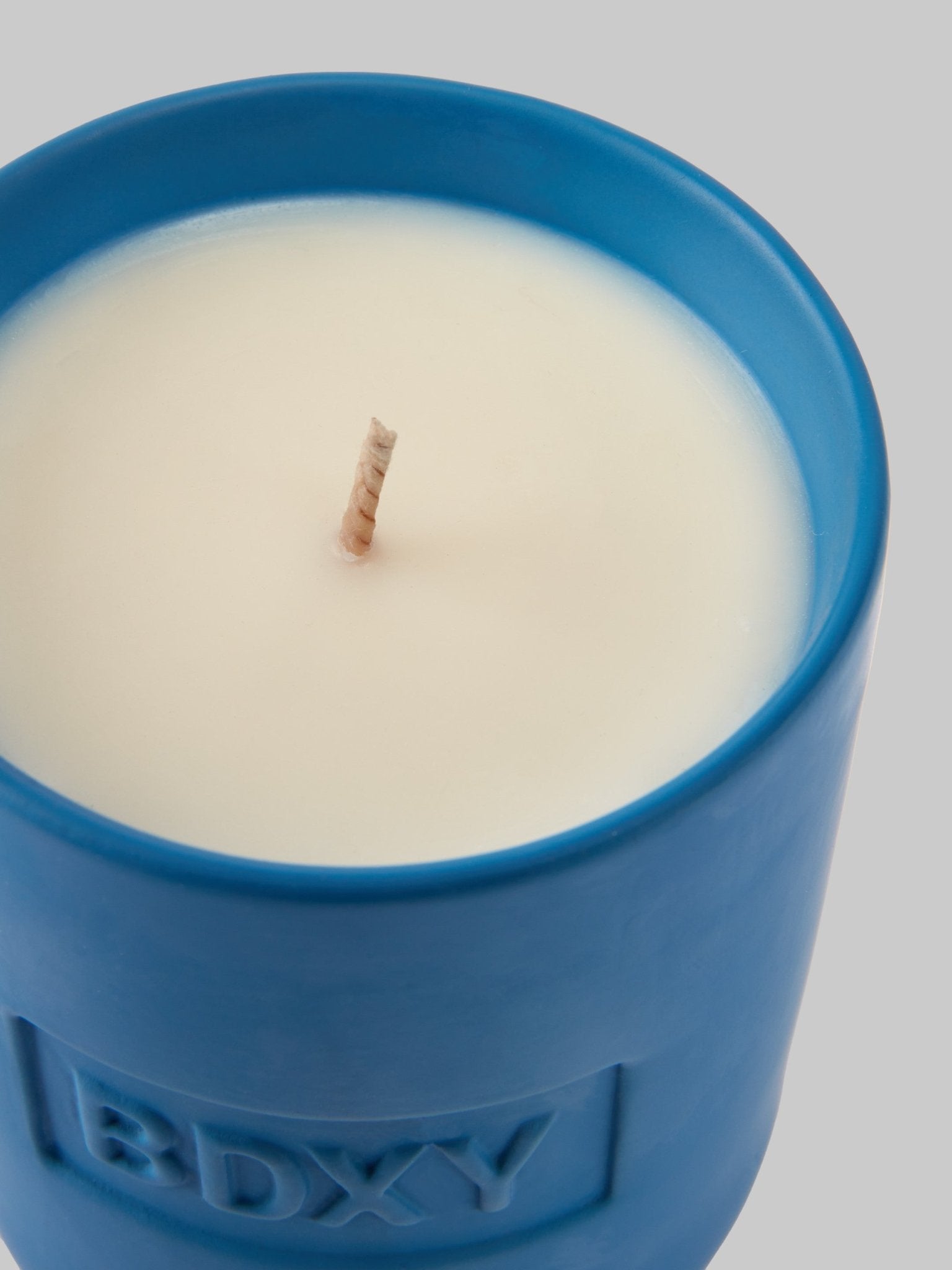 BDXY Studios scented candle labeled Salinas with a simple glass jar and white wax, set against a cozy background.