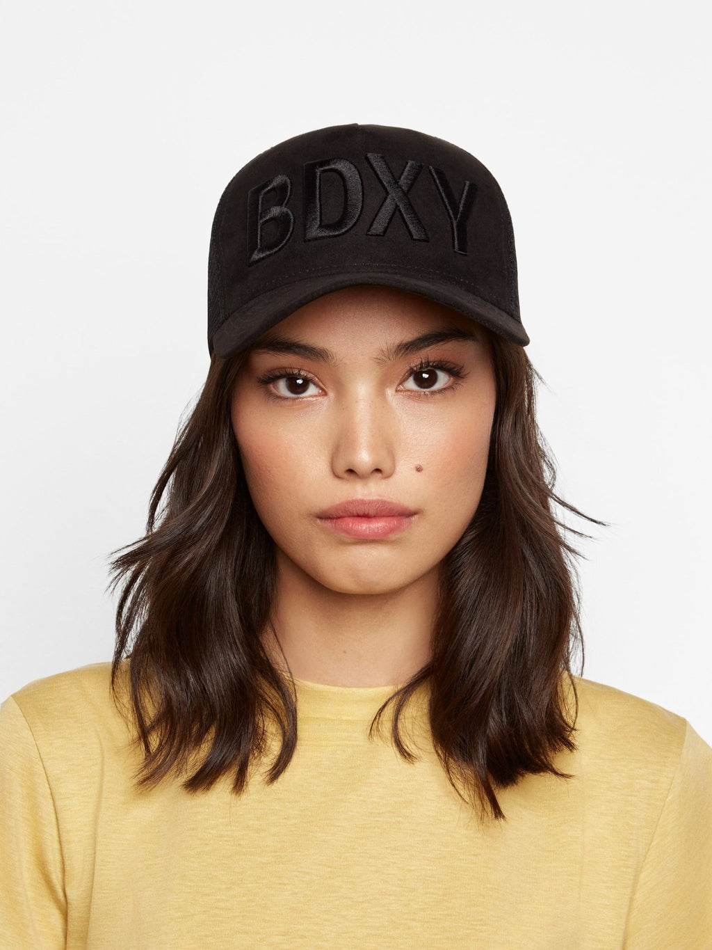 Black "The Gaffer" Trucker Cap by BDXY Studios featuring mesh back and curved brim, casual and adjustable for a stylish look.