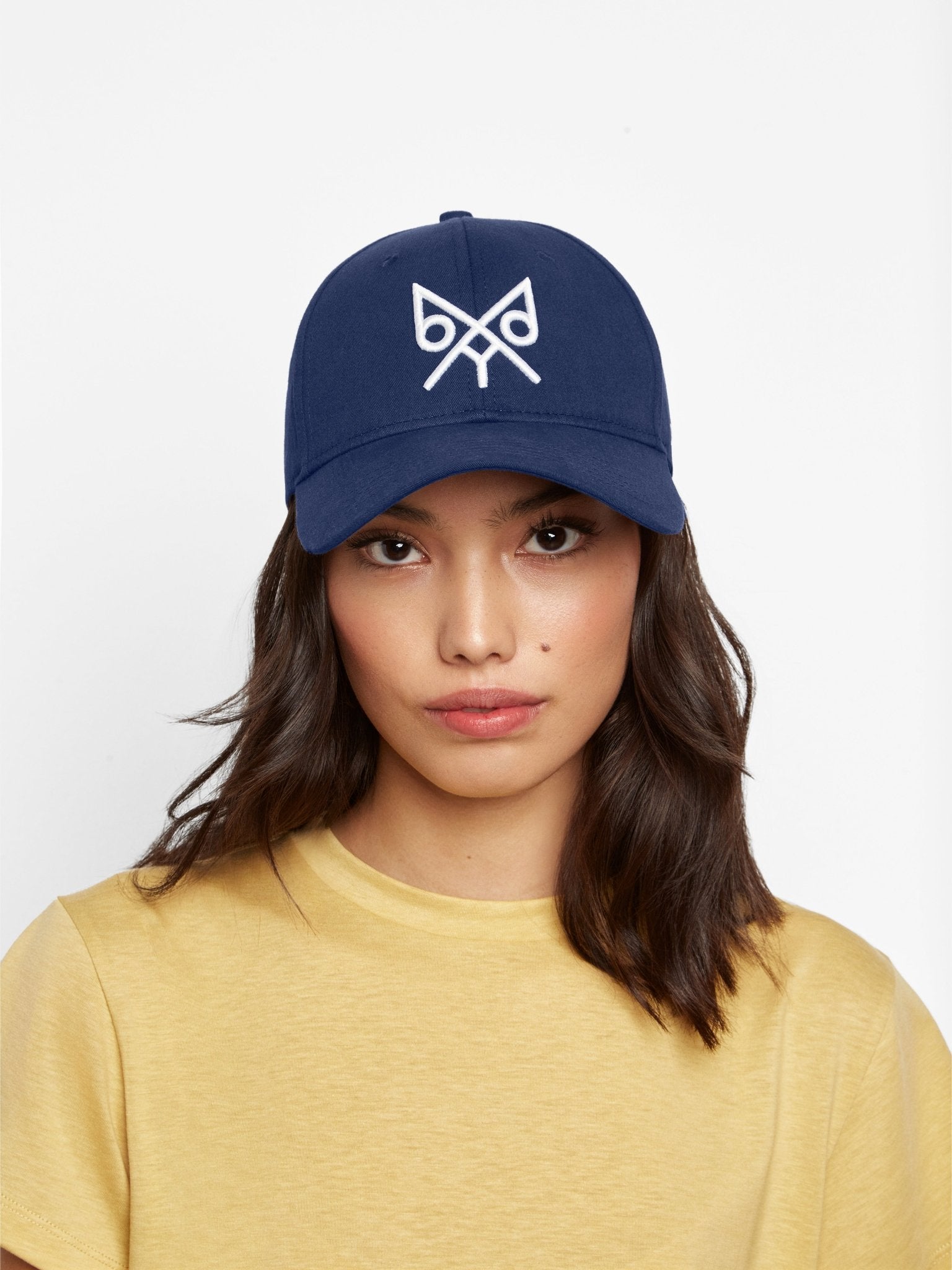 Navy "The Focus" baseball cap by BDXY Studios, featuring a curved brim and adjustable strap, displayed on a plain background.
