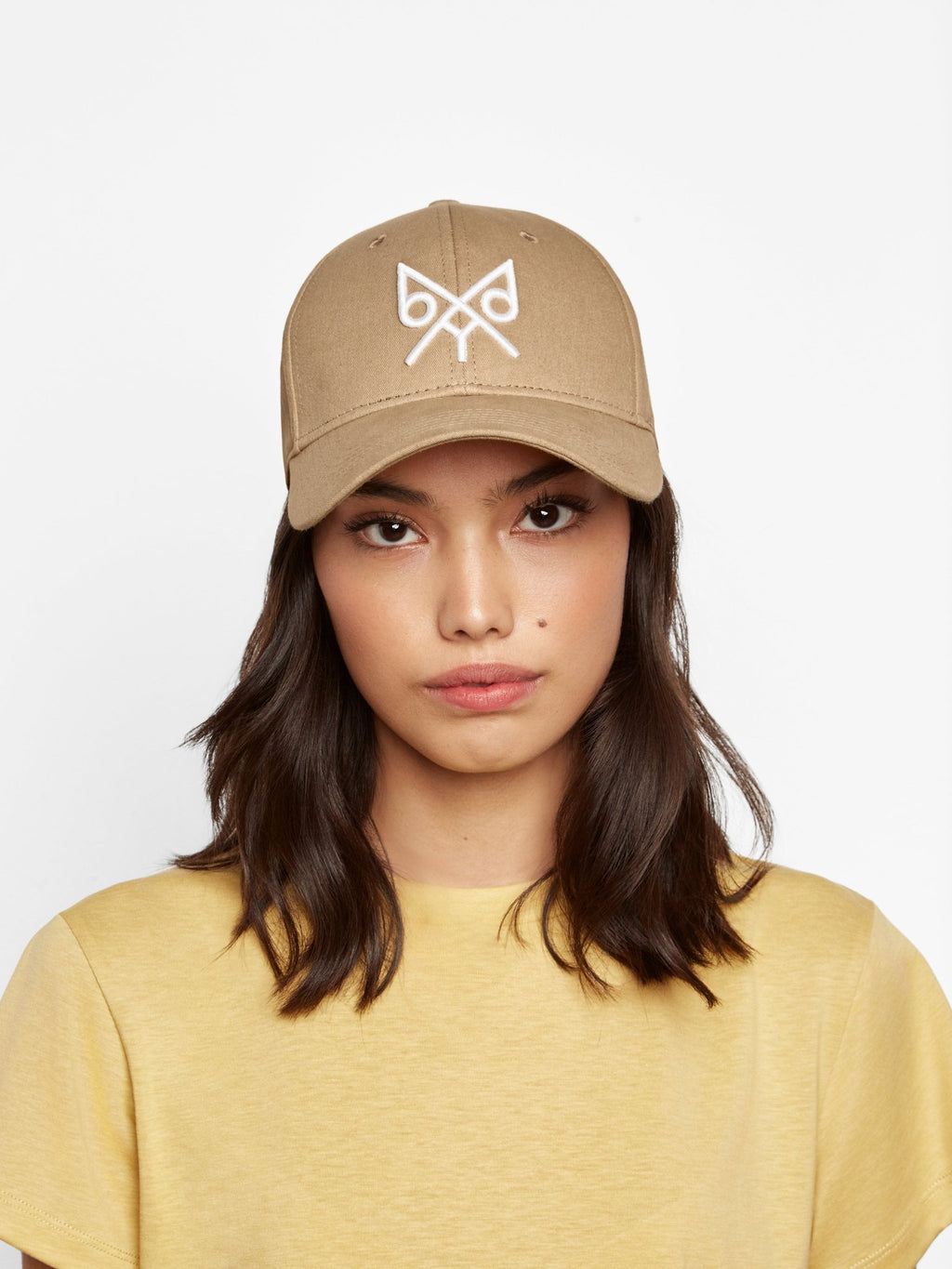 Tan baseball cap by BDXY Studios featuring "The Focus" design, casual cap with curved brim and adjustable strap.