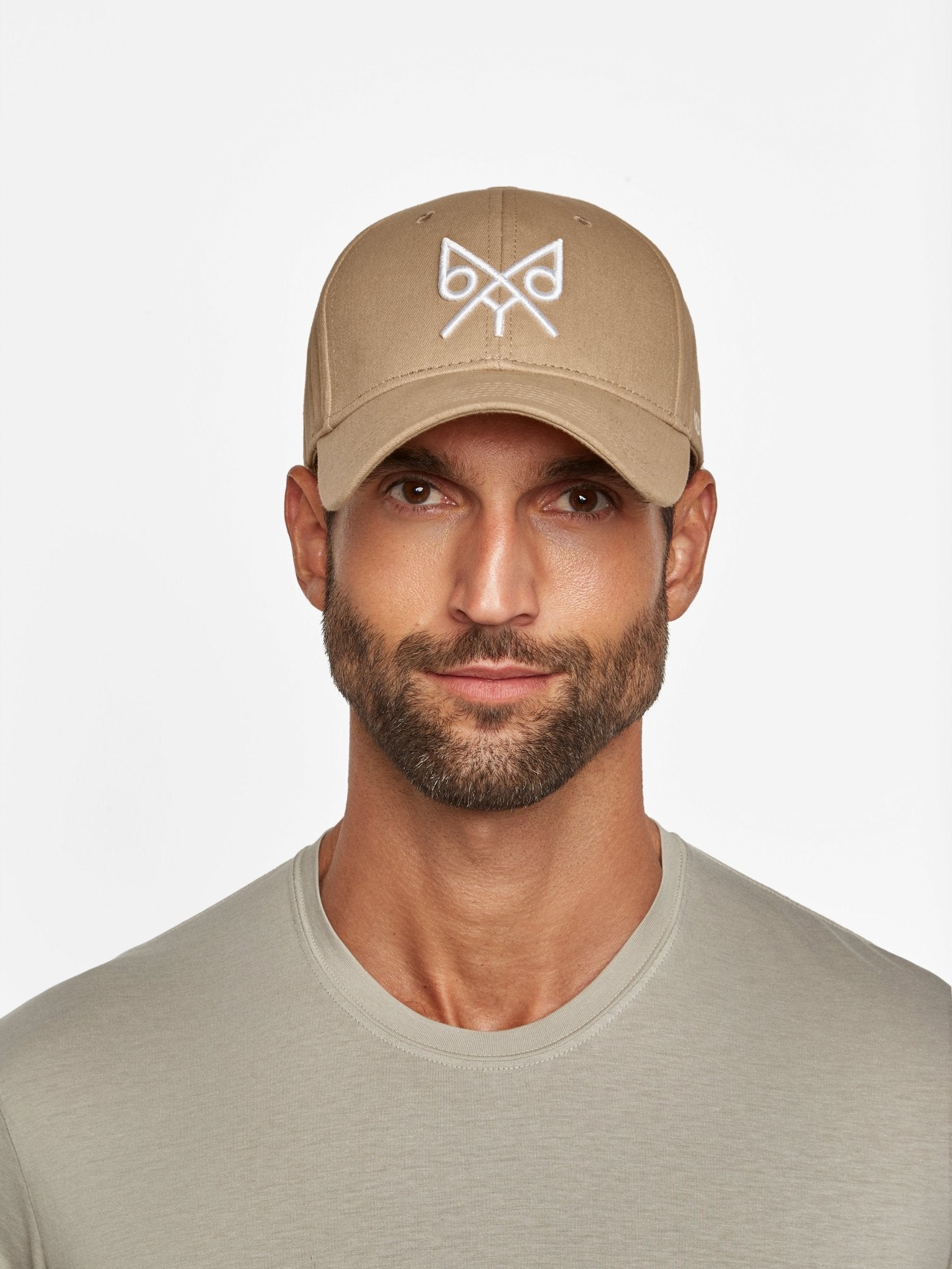 Tan "The Focus" baseball cap by BDXY Studios, adjustable cap with curved brim and breathable fabric, shown from front view.