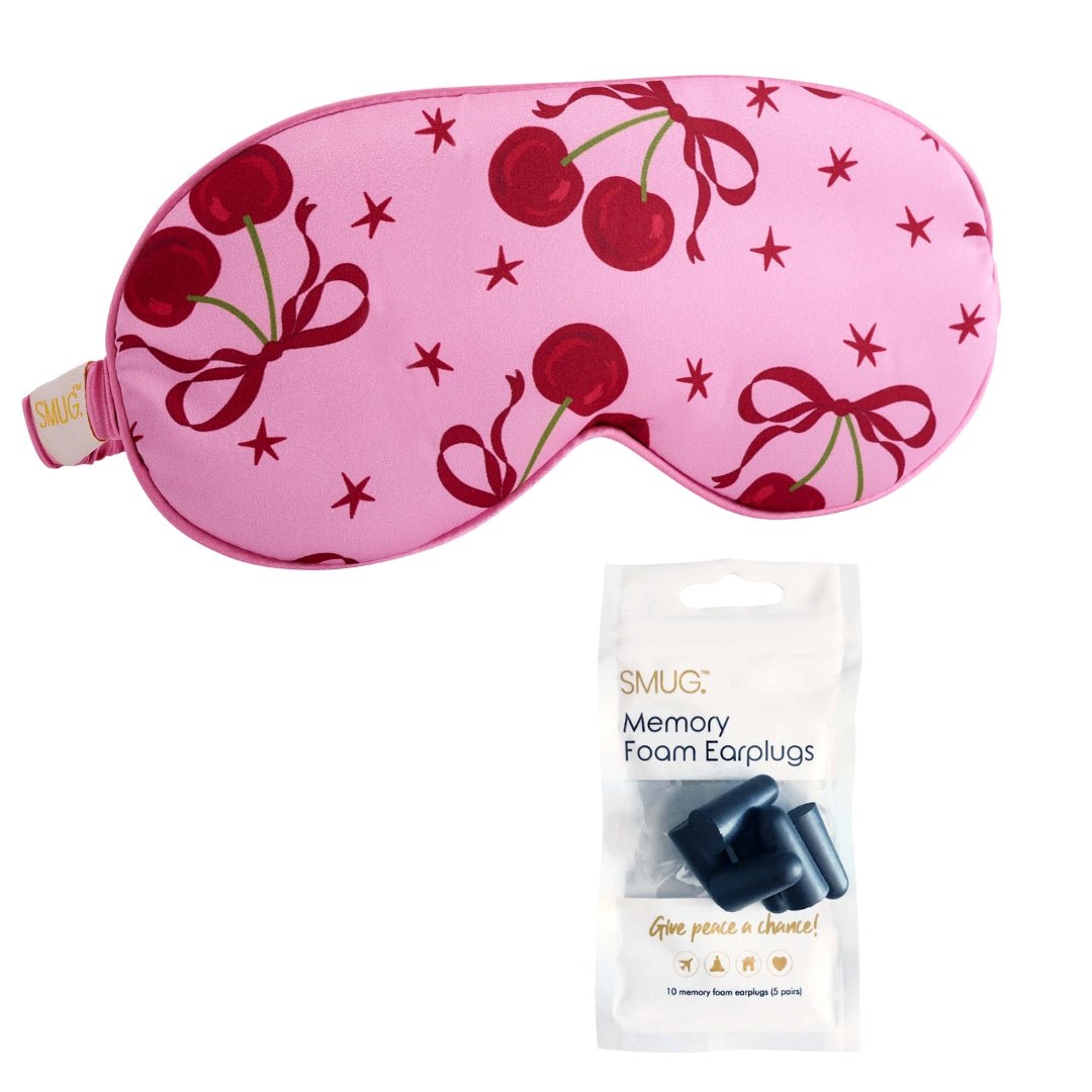 Pink satin sleep mask with cherry print by SMUG, featuring a smooth, soft fabric and comfortable design for restful sleep.