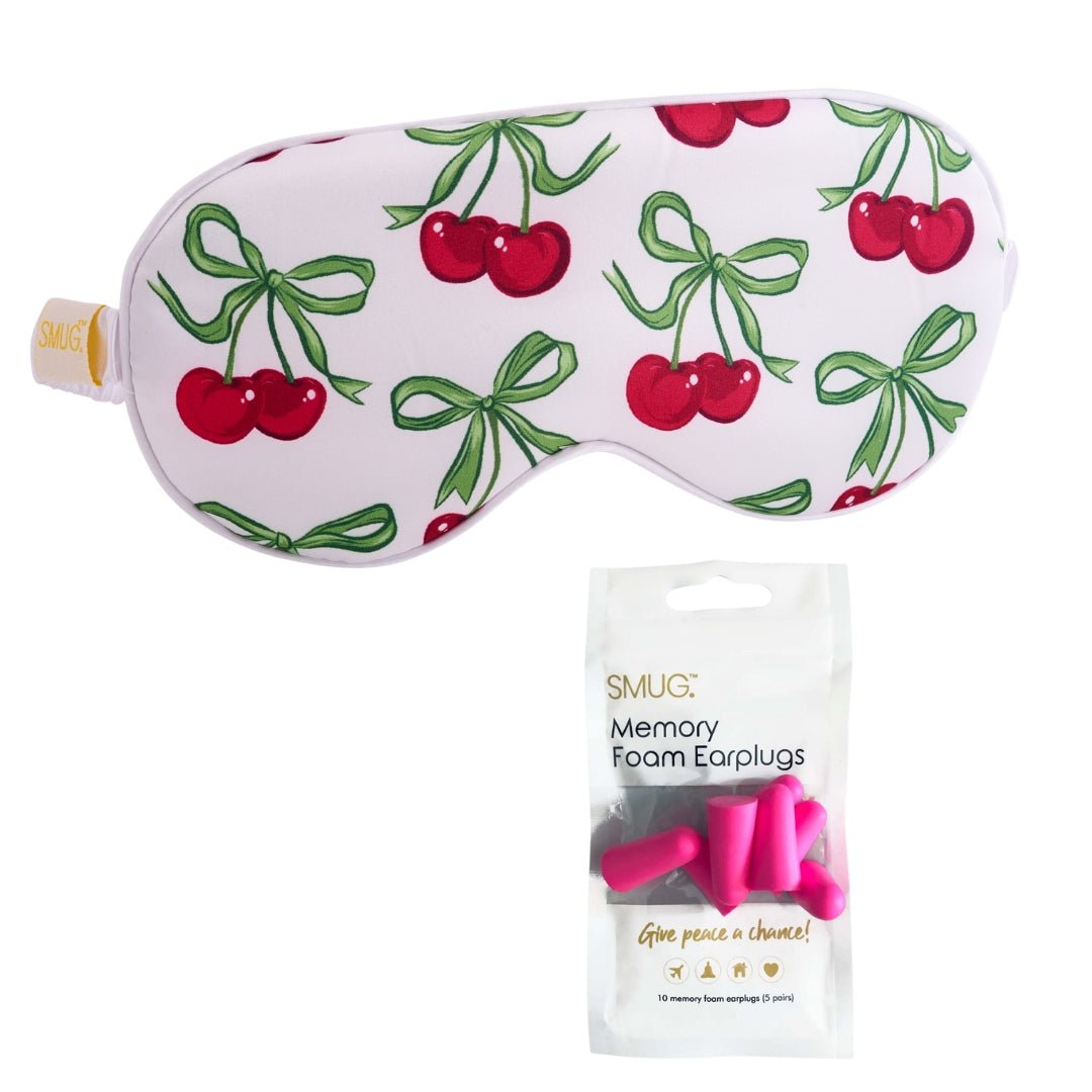 White satin sleep mask with cherry print by SMUG, featuring a smooth, soft fabric for comfortable nighttime sleep.