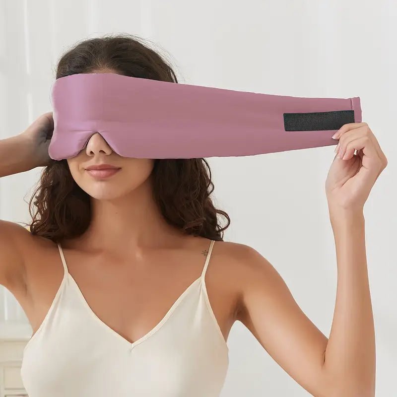 Black silk sleep mask by DREAMSILK, designed to block light and provide comfortable, restful sleep.