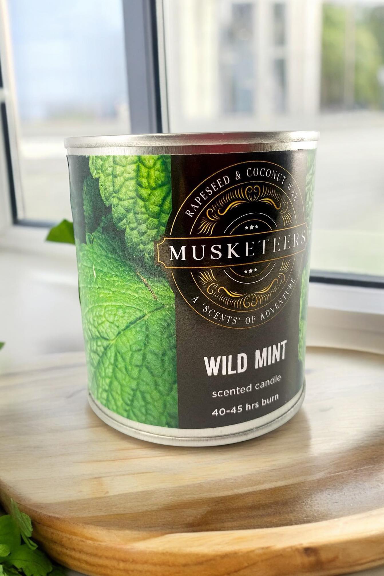 Musketeers Wild Mint scented candle with fresh, masculine spa aroma, featuring a green candle in a glass holder.