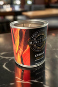 Musketeers Cuban Tobacco Candle UK with tobacco and oak scent, masculine candle featuring a dark wax and a lit wick.