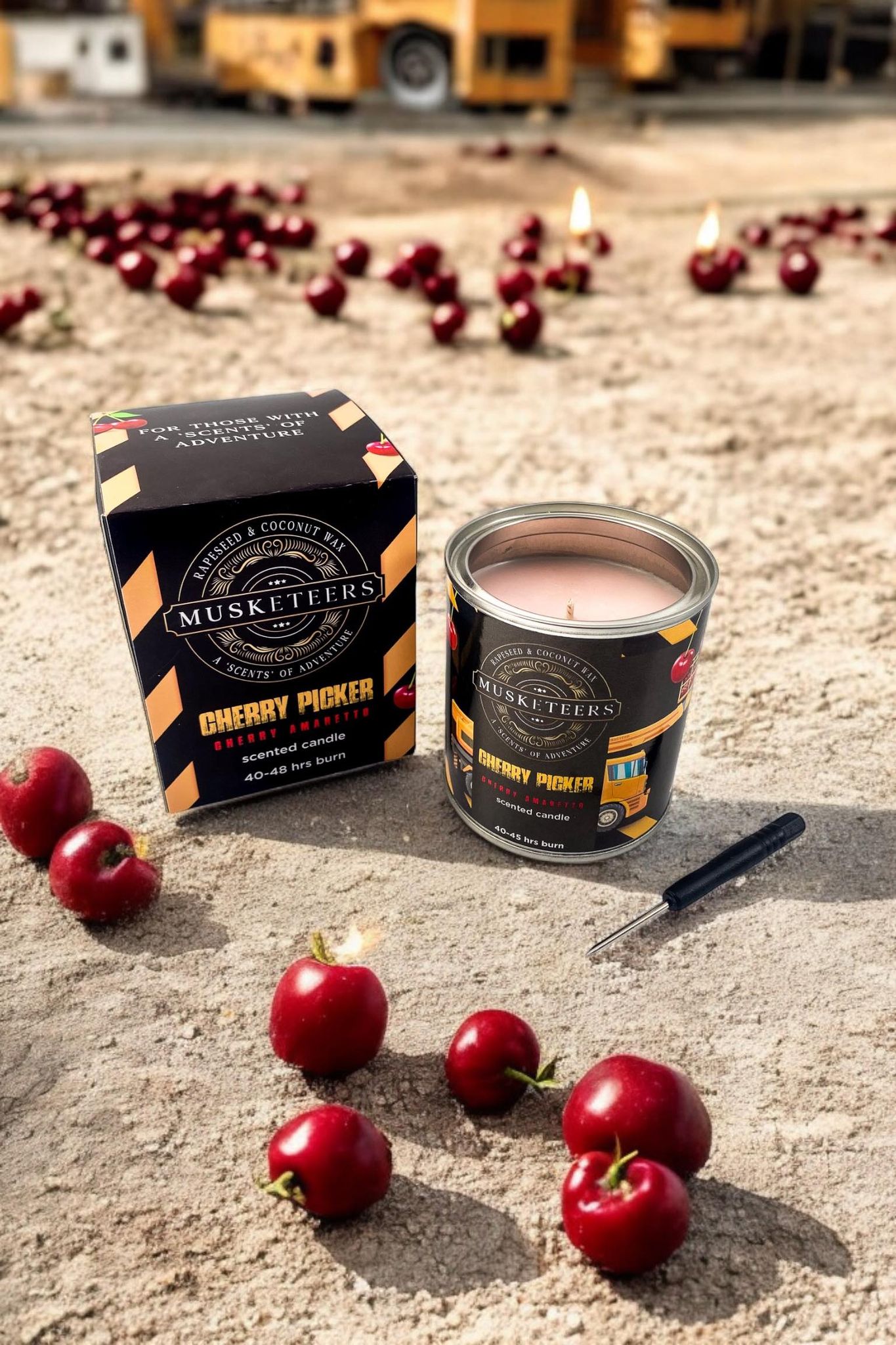 Cherry Amaretto Candle by Musketeers, featuring a glass jar with cherry and almond scent, lit with a warm glow.