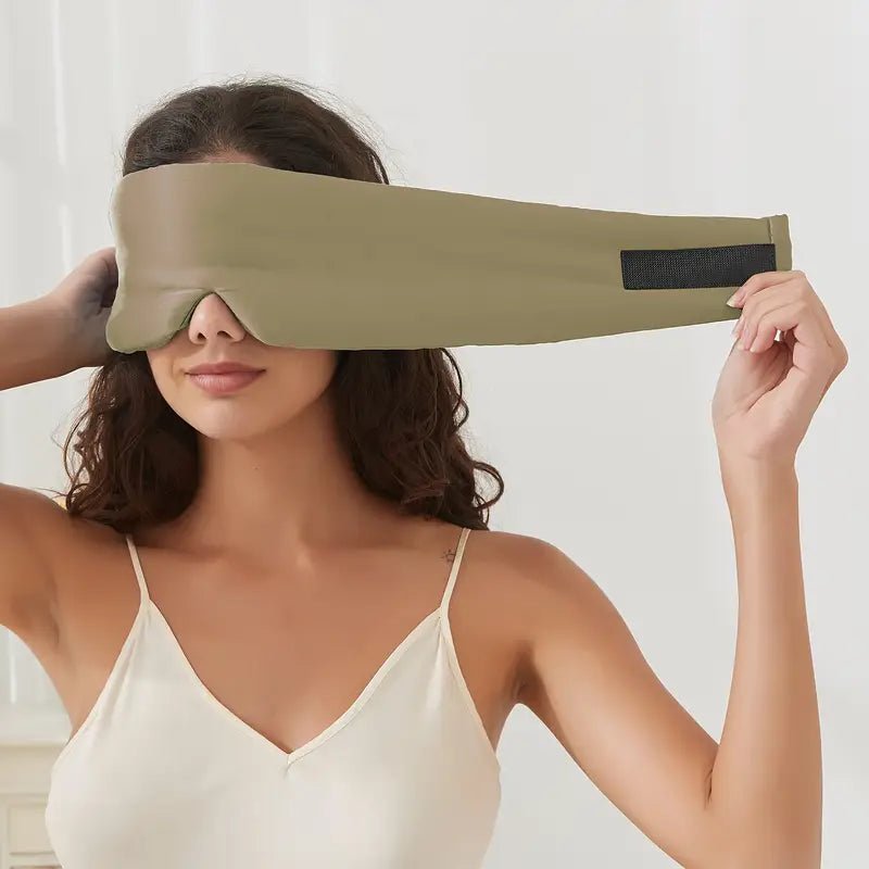 Black silk sleep mask by DREAMSILK, soft and luxurious with a smooth, blackout design for restful sleep.