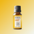Scandiscents Positive Energy essential oil blend in a glass bottle with a wooden cap, surrounded by citrus and herbal ingredients.