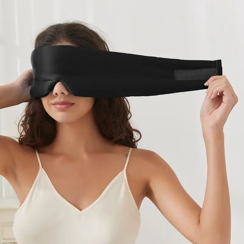 Black Silk Sleep Mask by DREAMSILK with smooth, luxurious fabric and adjustable strap for comfortable, complete blackout sleep.