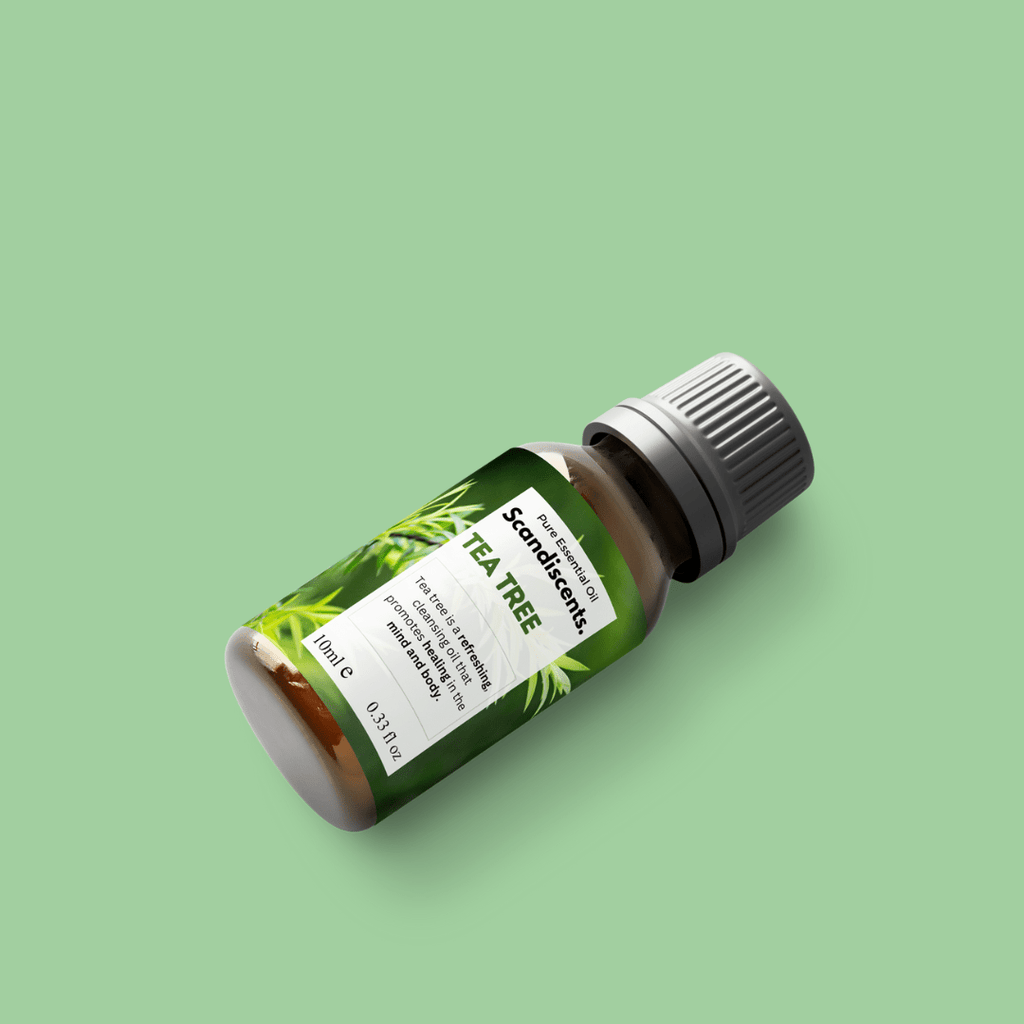 Scandiscents Tea Tree Essential Oil bottle with dropper cap, showcasing clear glass packaging and green label.