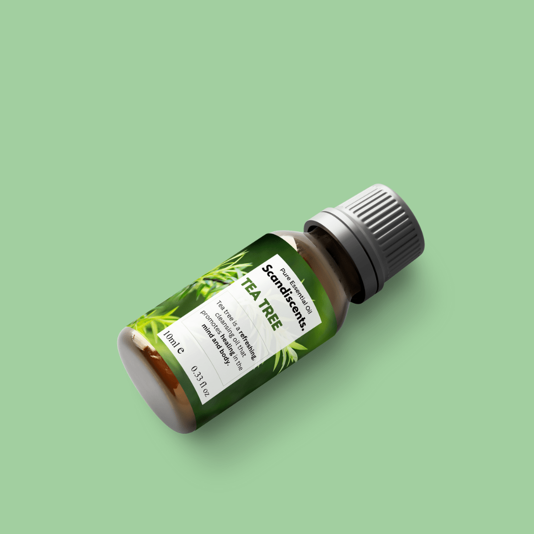 Scandiscents Tea Tree Essential Oil bottle with dropper cap, showcasing clear glass packaging and green label.
