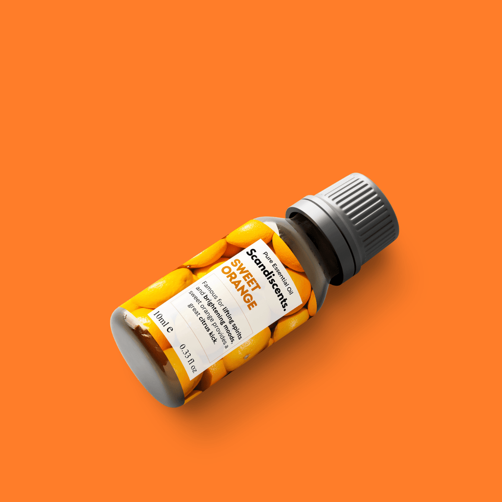 Scandiscents Sweet Orange essential oil bottle with orange-colored label and dropper cap on a white background.