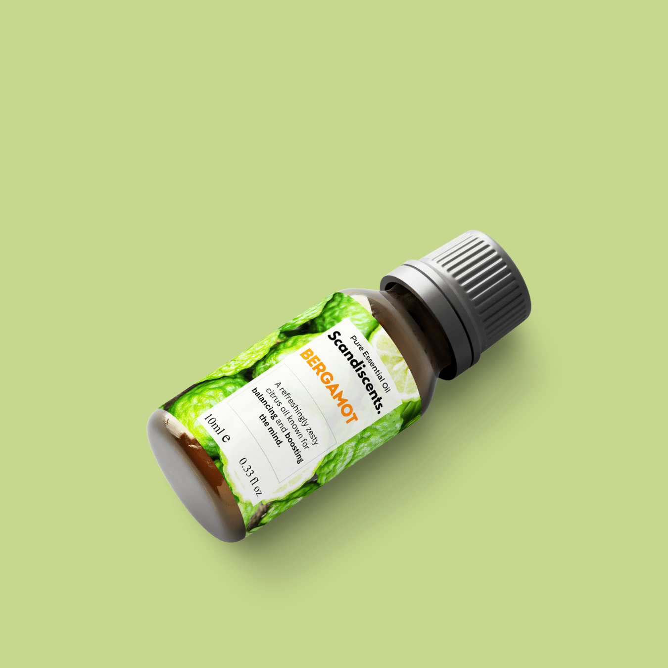 Scandiscents bergamot essential oil bottle with orange citrus slices and a dropper, showcasing natural and aromatic oil.