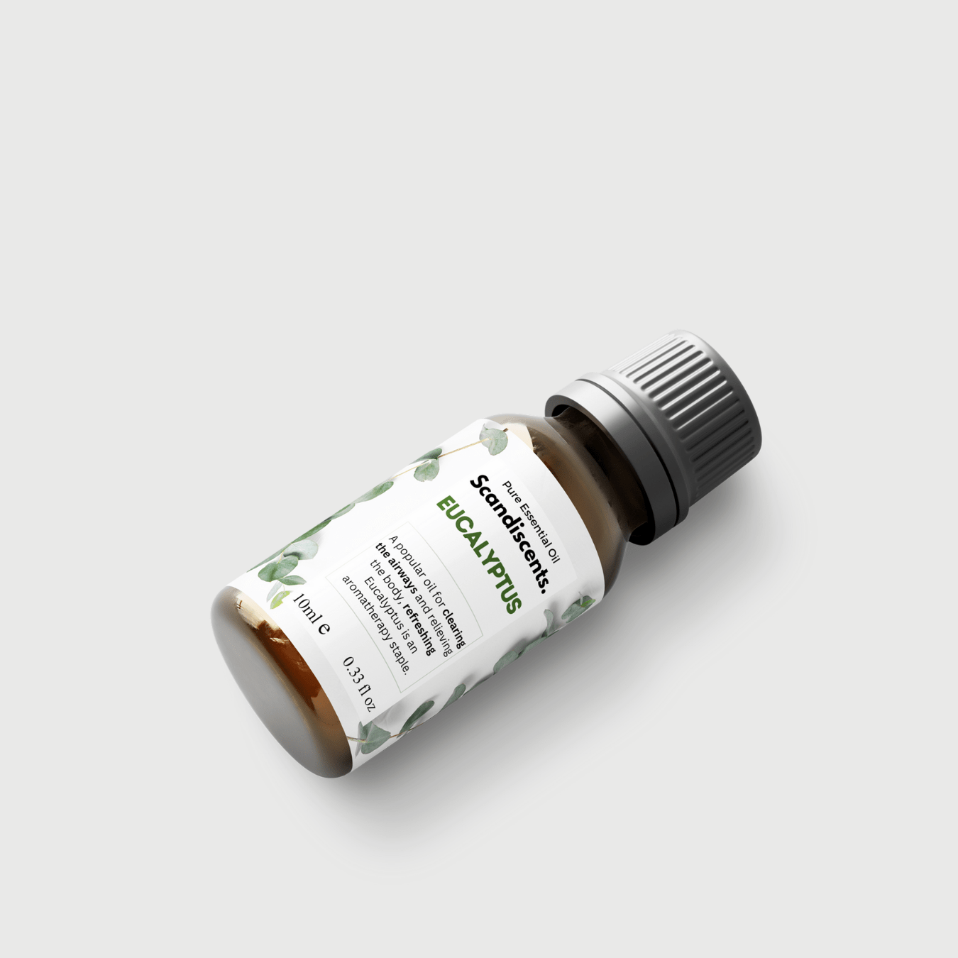 Bottle of Scandiscents eucalyptus essential oil with a green label and natural eucalyptus leaves in the background.