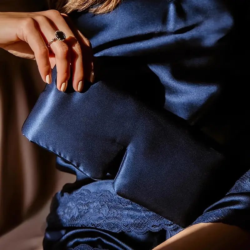 DREAMSILK black silk sleep mask with contoured design for blocking out light and enhancing restful sleep.