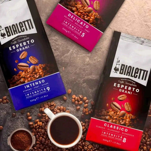 Bialetti Brew Italia whole bean coffee in a bag, showing roasted coffee beans and branding on the packaging.