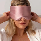 Black silk sleep mask by DREAMSILK, featuring a smooth, blackout design for comfortable nighttime sleep.