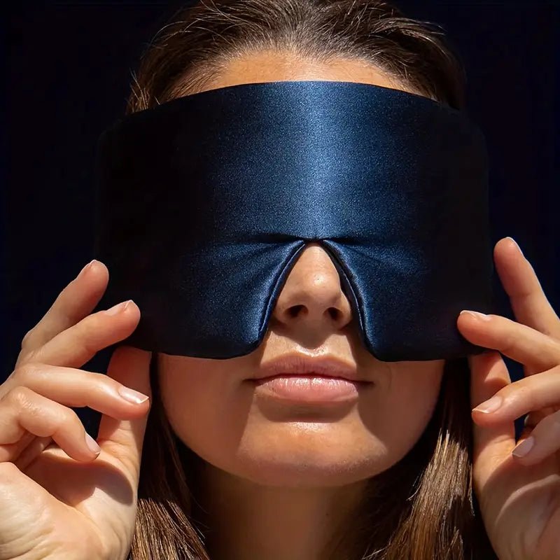 Black silk sleep mask from DREAMSILK, designed for blackout sleep and comfortable night rest.