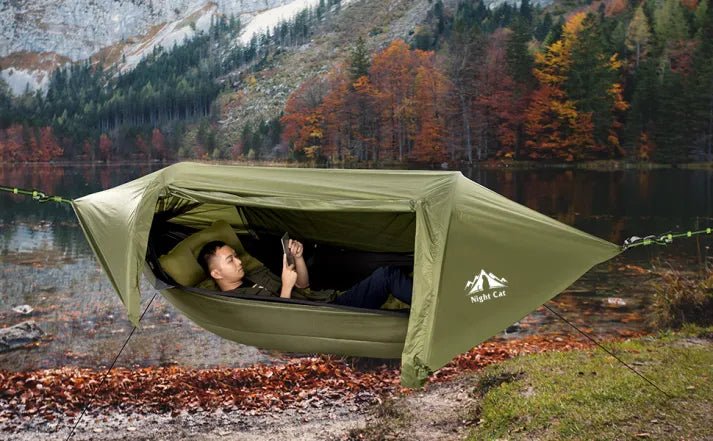 HikeWare Night Cat Hammock Tent hanging between trees, showcasing its compact, lightweight design for outdoor camping and relaxation.