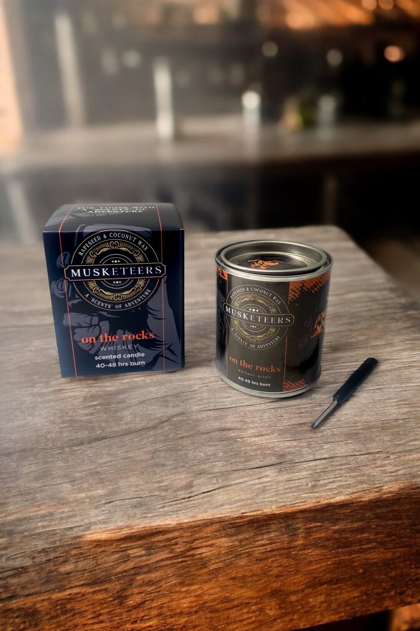 Whisky scented candle by Musketeers featuring a sleek glass jar and warm, masculine design for a luxurious ambiance.