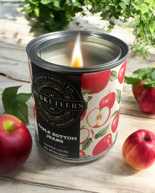 Apple Bottom Jeans Candle by Musketeers featuring a jar with a label, showcasing a fresh apple and pear scent.