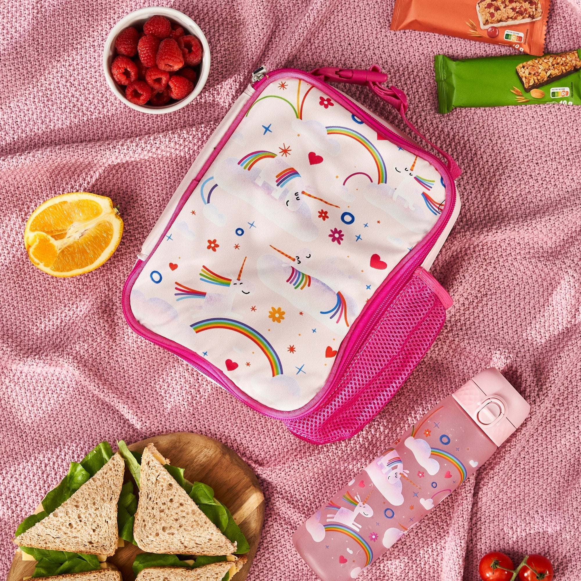 Insulated kids lunch bag with unicorn and rainbow design by ION8, featuring a medium size and colorful printed pattern.