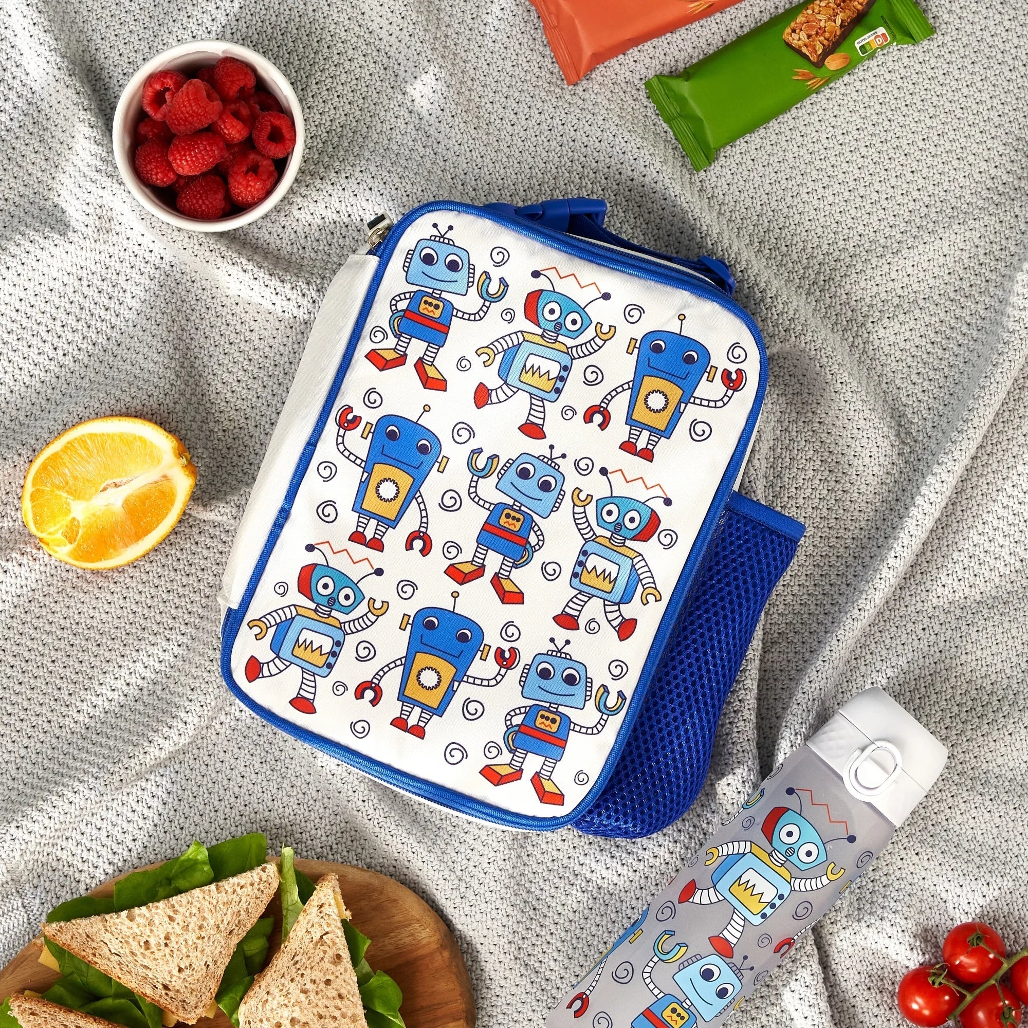 Insulated kids lunch bag with robot design, medium size, ION8 brand, featuring colorful robot illustrations on the front.