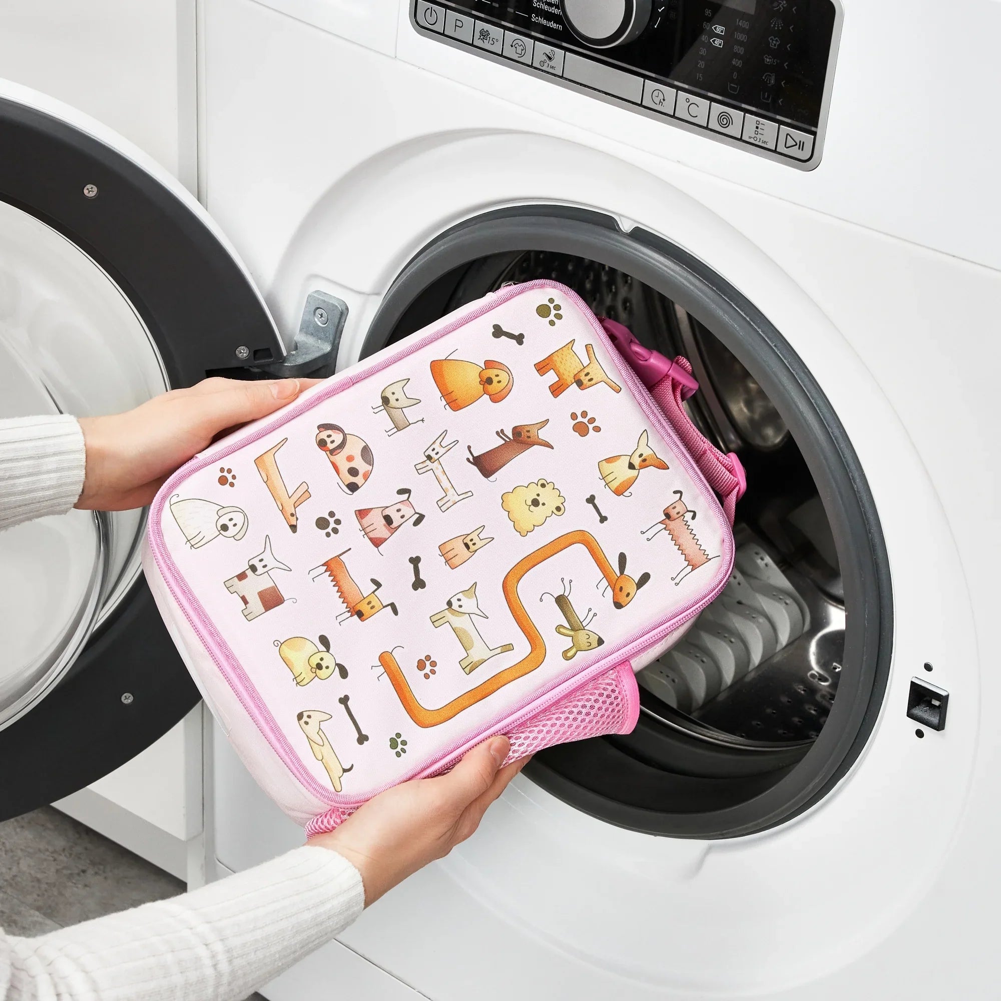 Medium insulated kids lunch bag by ION8 featuring playful dog design, perfect for keeping food fresh.