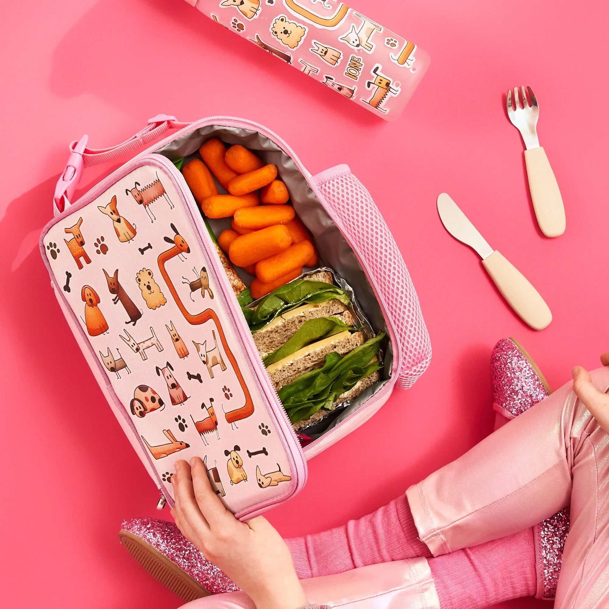 Insulated kids lunch bag by ION8 featuring a playful dog design, perfect for keeping lunch fresh and organized.