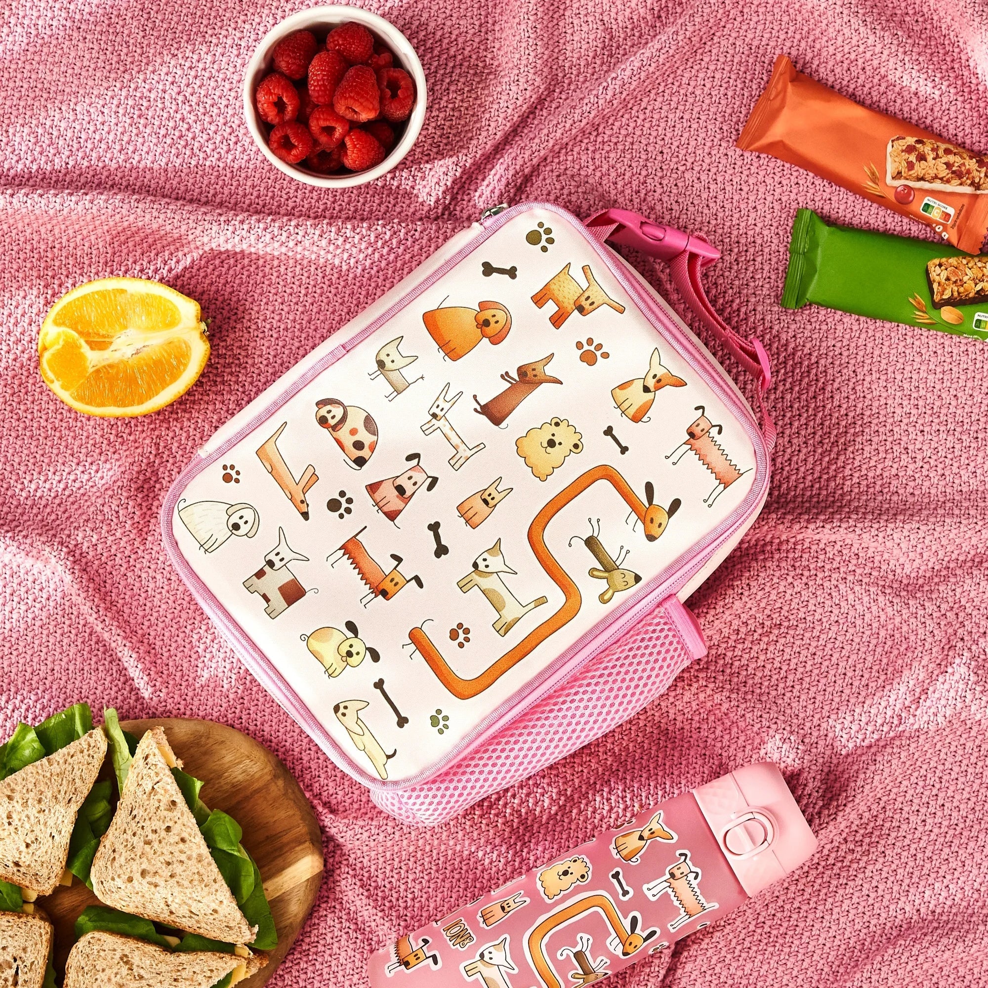 Medium insulated kids lunch bag by ION8 featuring playful dog designs, perfect for keeping snacks fresh.