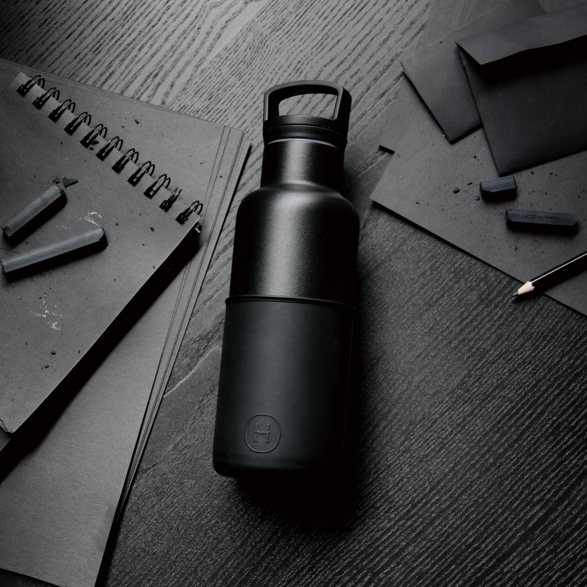 Black ink bottle by HYDY, 16 oz, featuring a sleek black container with a twist-off cap, suitable for art and writing projects.