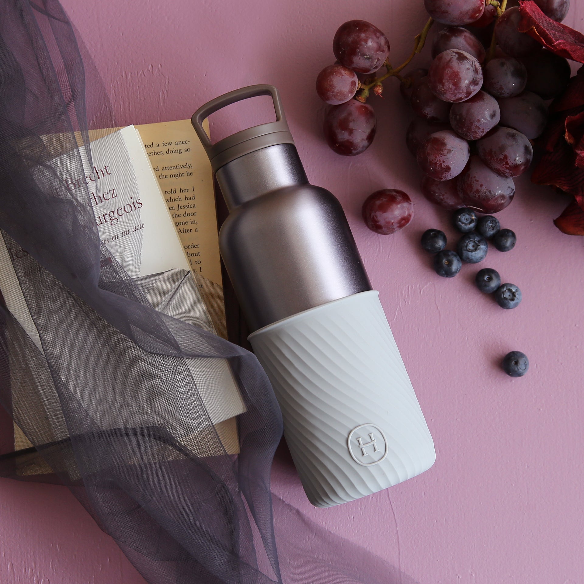 HYDY dusk violet and cloudy grey 16 oz bottle with a sleek, modern design and transparent body showing the liquid inside.