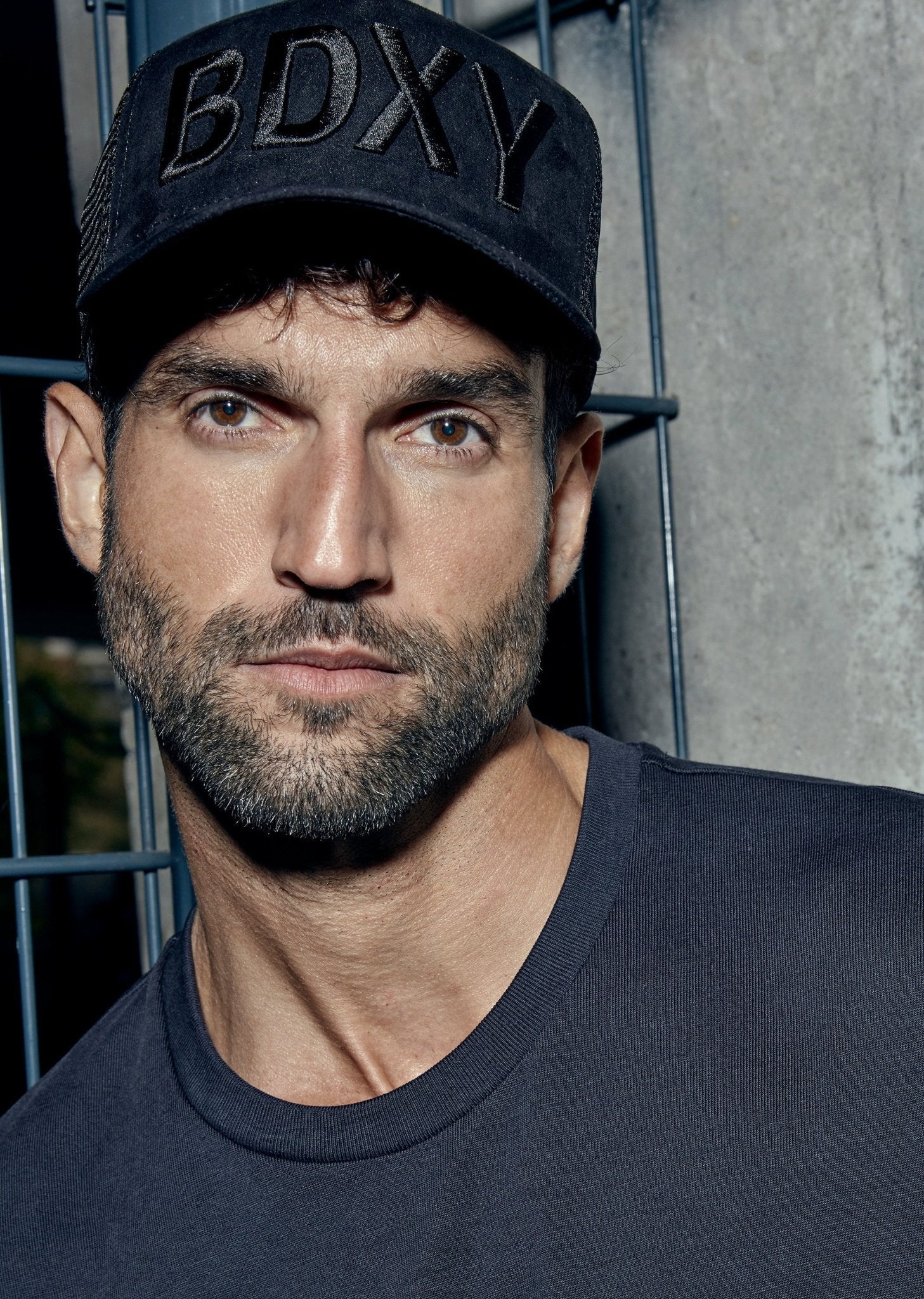Black "The Gaffer" trucker cap by BDXY Studios featuring a mesh back and curved brim.