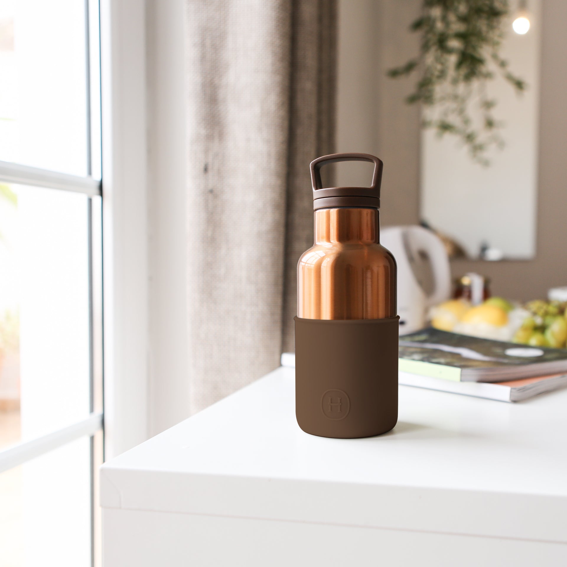 HYDY bronze gold-mocha 12 oz bottle with a sleek design, showcasing its metallic finish and compact shape.