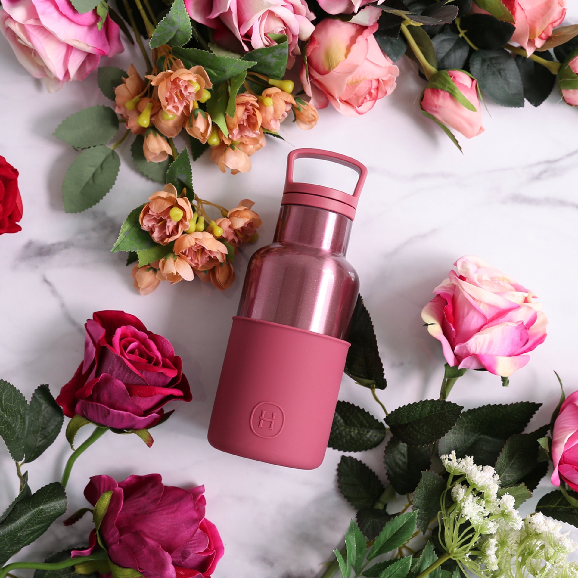 HYDY 12 oz rose gold and wine red glass bottle, showcasing elegant design and vibrant color for stylish beverage storage