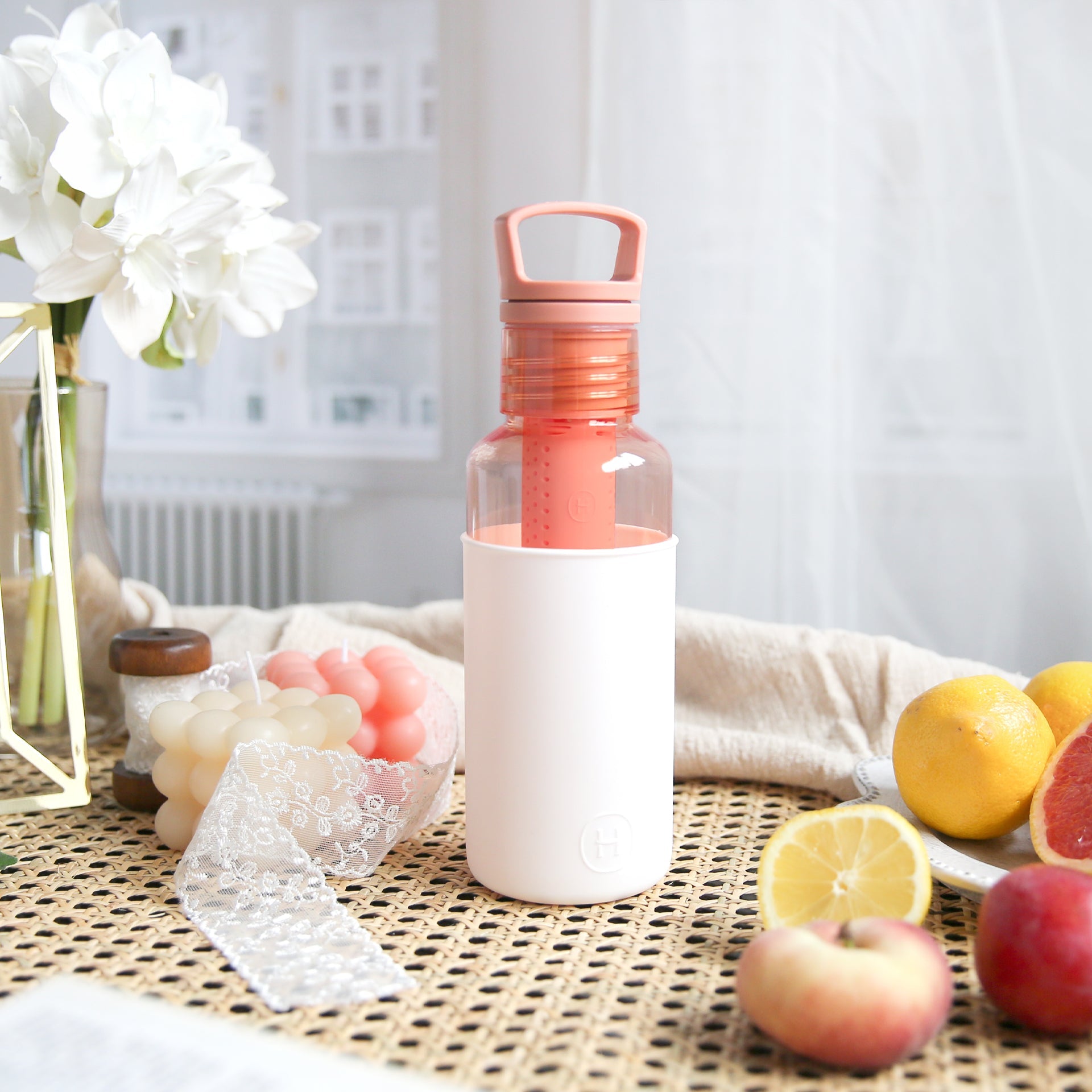 White and peach-orange HYDY 20 oz bottle with a sleek design, showcasing the durable plastic construction and secure lid.