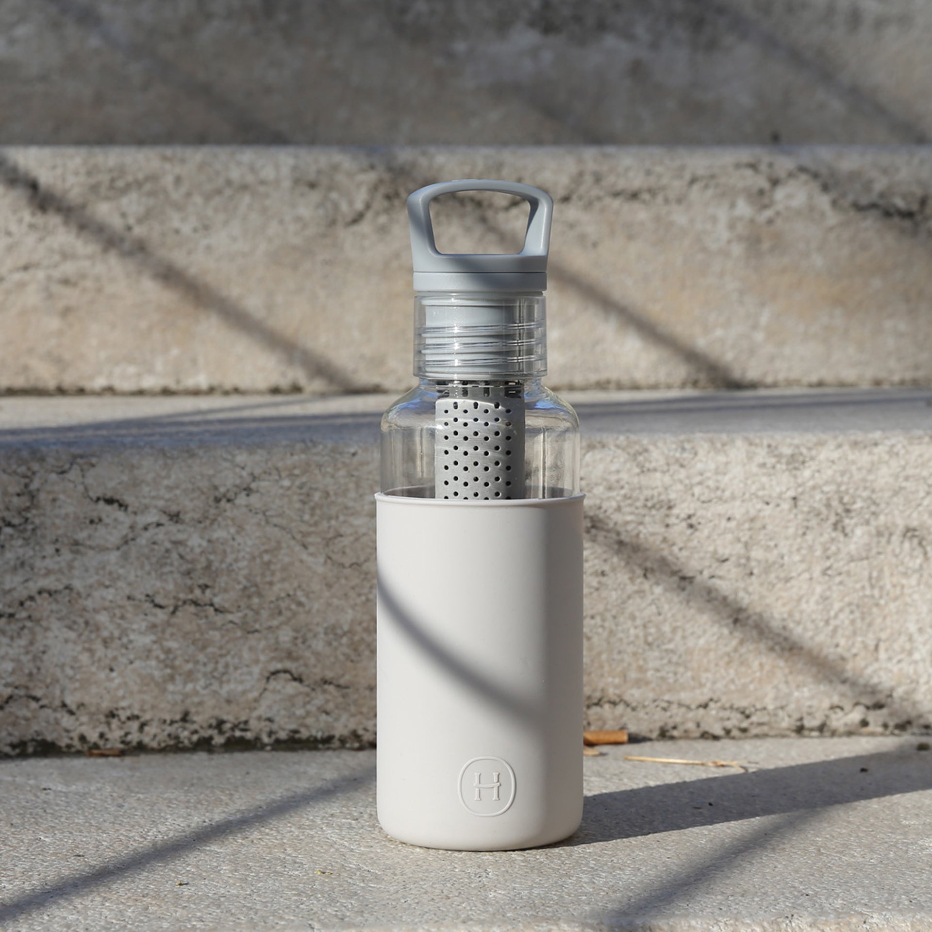 HYDY Clear-Cloudy Grey 20 oz bottle showing a sleek, transparent grey plastic container with a secure lid.