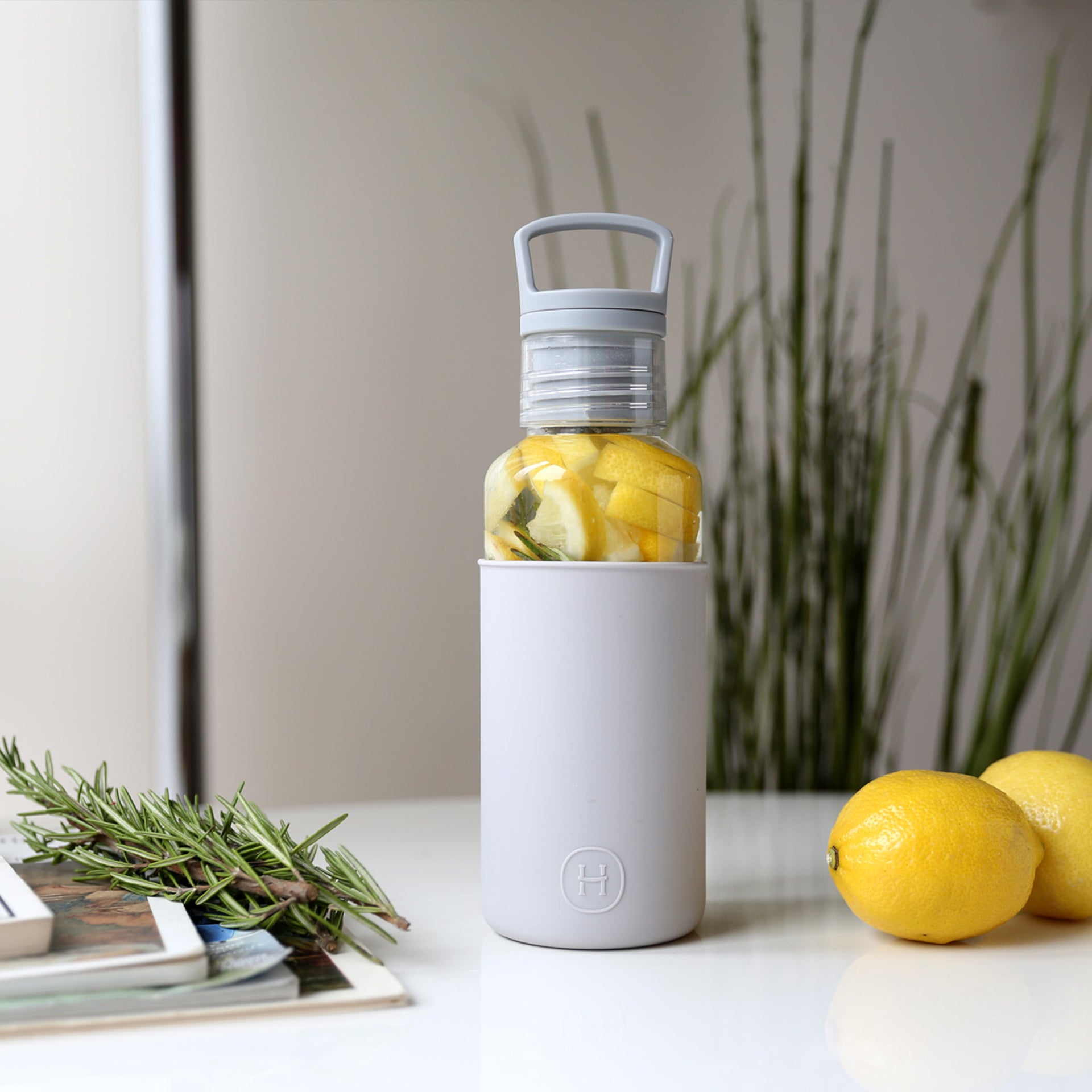 HYDY 20 oz clear and cloudy grey bottle, durable plastic container with a screw cap, ideal for beverages or storage.