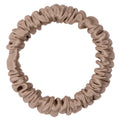 Light tan silk scrunchie by DREAMSILK, skinny style, shown in beige fabric with smooth, shiny silk texture.