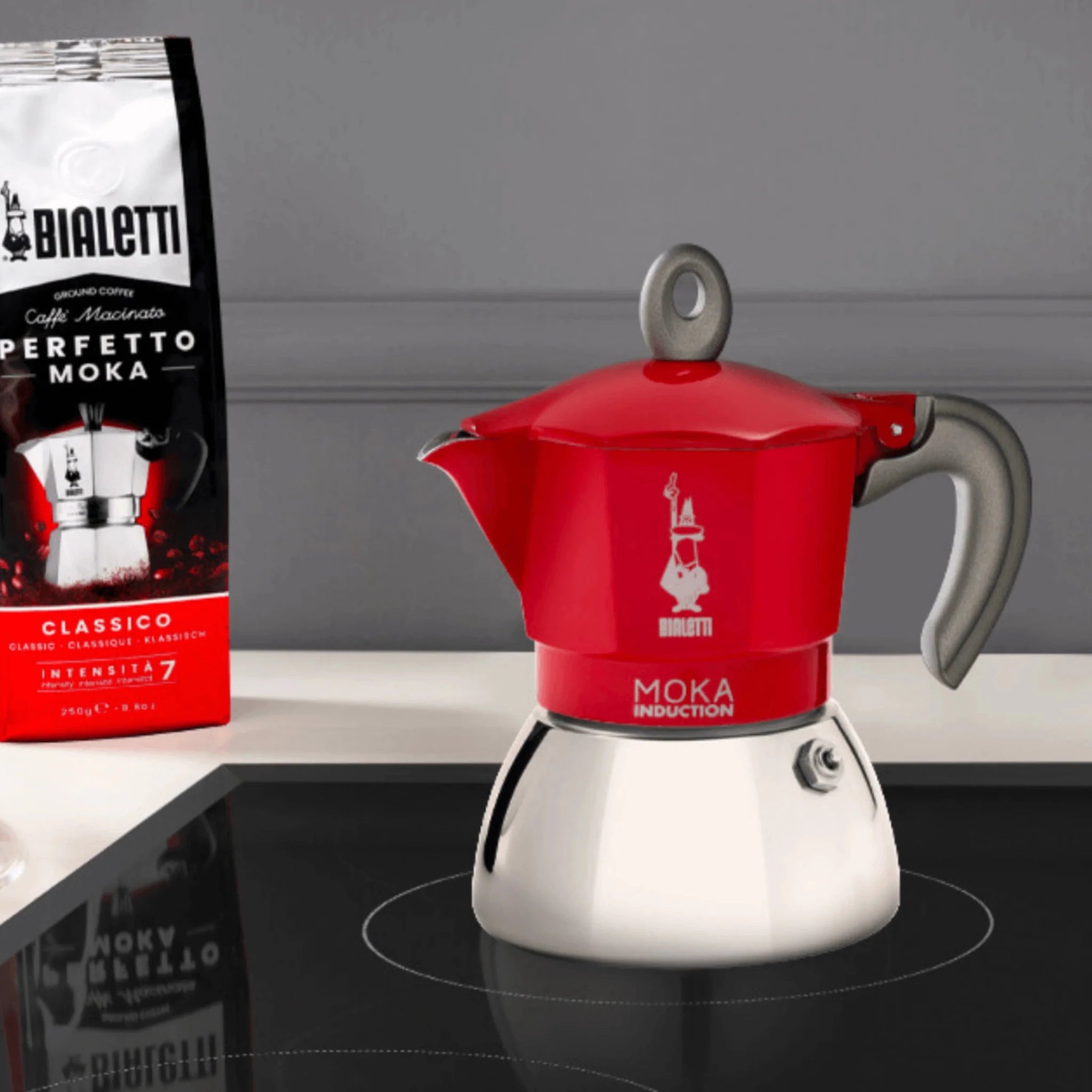 Red Bialetti Moka Induction stovetop coffee maker with sleek design and Brew Italia branding, perfect for brewing espresso-style coffee.