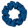 Navy blue silk scrunchie from DREAMSILK, showing soft, shiny silk fabric and elastic band for gentle hair hold.