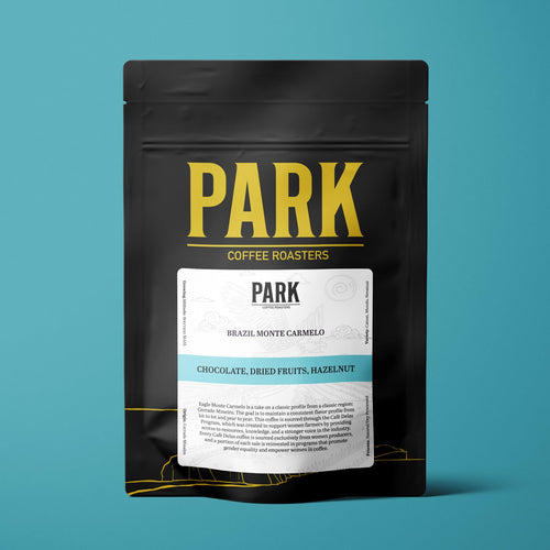 Roasted Brazil Eagle Monte Carmelo coffee beans by Park Coffee, showing glossy, dark roasted coffee beans in a close-up image.