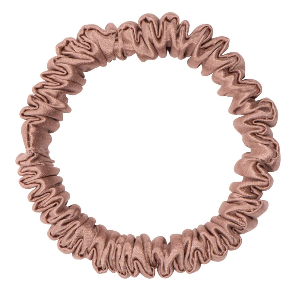 Bronze silk scrunchie by DREAMSILK, skinny style, made of smooth, shiny silk fabric, shown coiled on a white background.