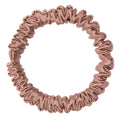 Bronze silk scrunchie by DREAMSILK, skinny style, made of smooth, shiny silk fabric, shown coiled on a white background.