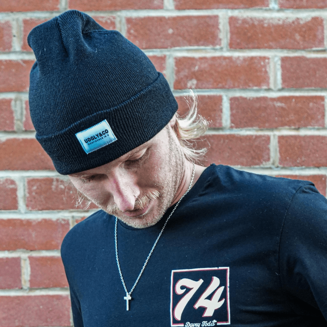 Uggly and Co Davey Todd 74 beanie, soft knit hat with logo patch, in black, designed for warmth and casual style.