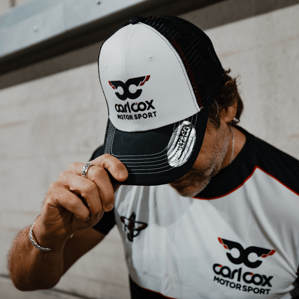 Uggly and Co Carl Cox icon trucker hat featuring a classic trucker cap design with DJ Carl Cox logo on the front panel.